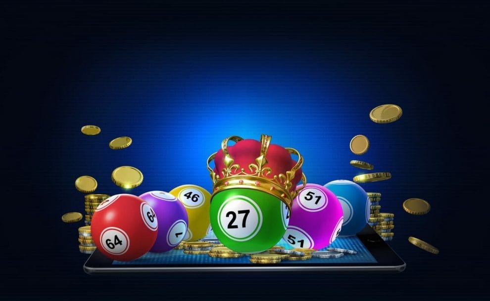 An illustration of bingo balls on top of a mobile phone. The bingo balls are surrounded by coins. The green 27 bingo ball has a crown on top of it.