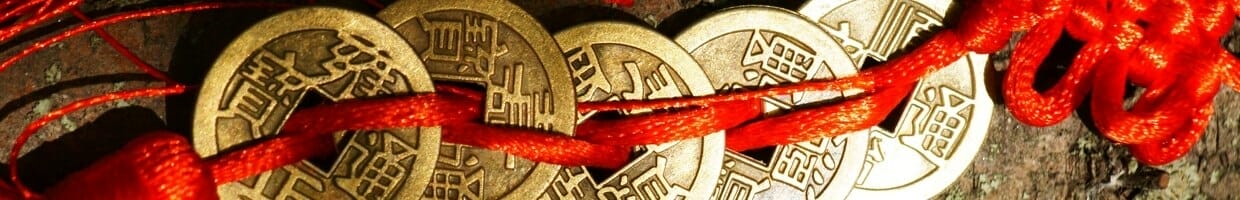Feng Shui coins tied together with red string.