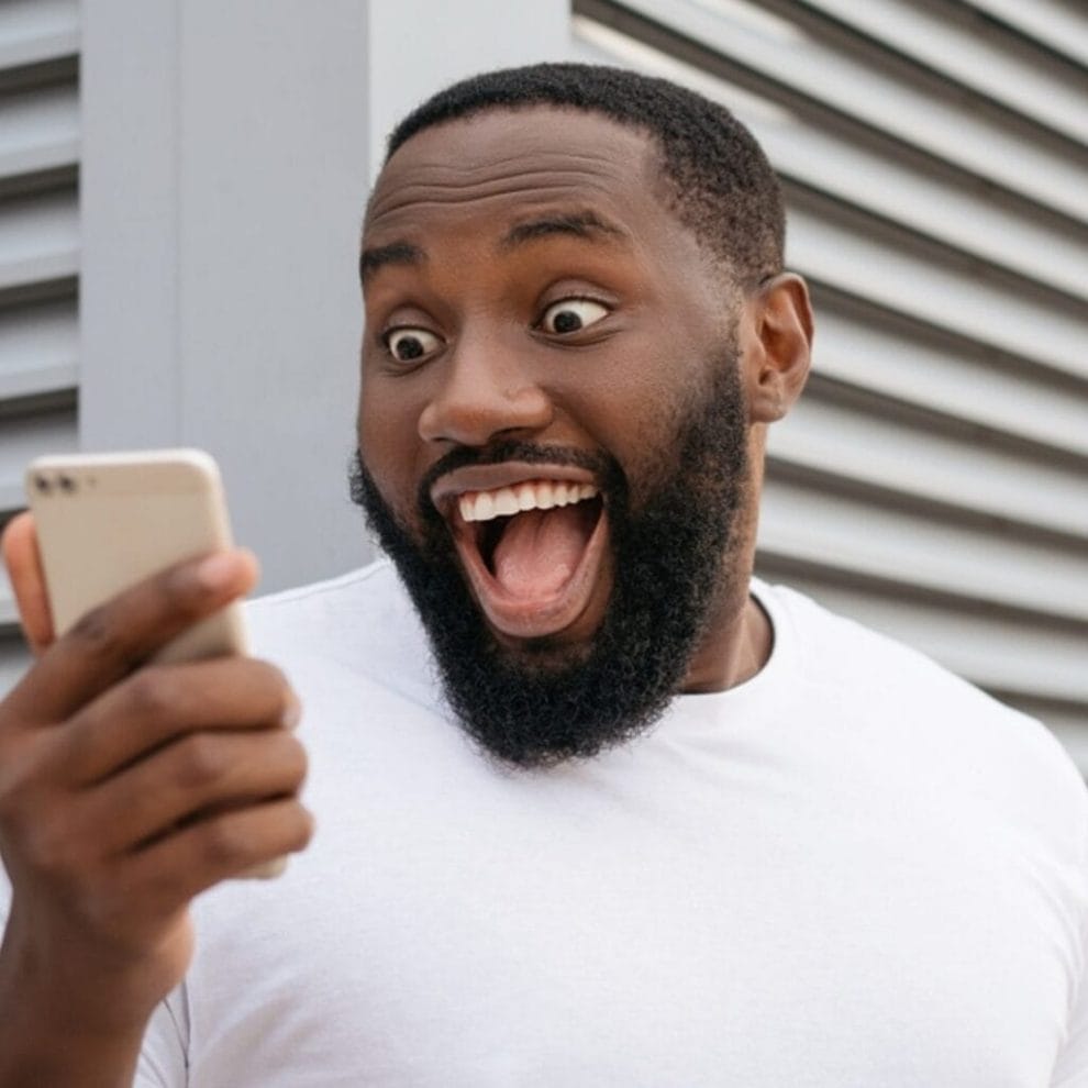 A man celebrates winning an online jackpot on his phone