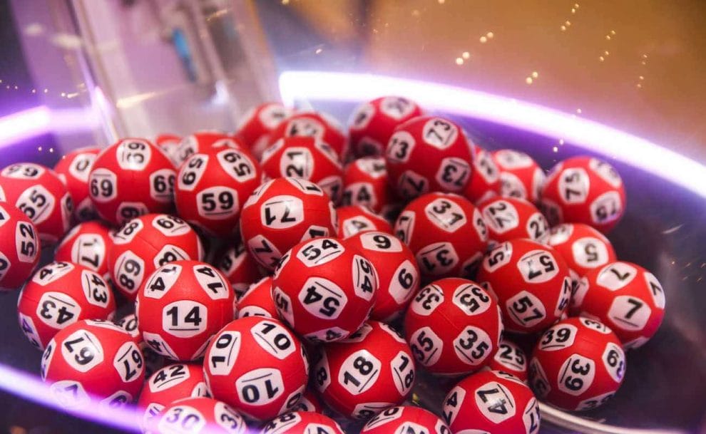 Red bingo balls with different numbers on them.