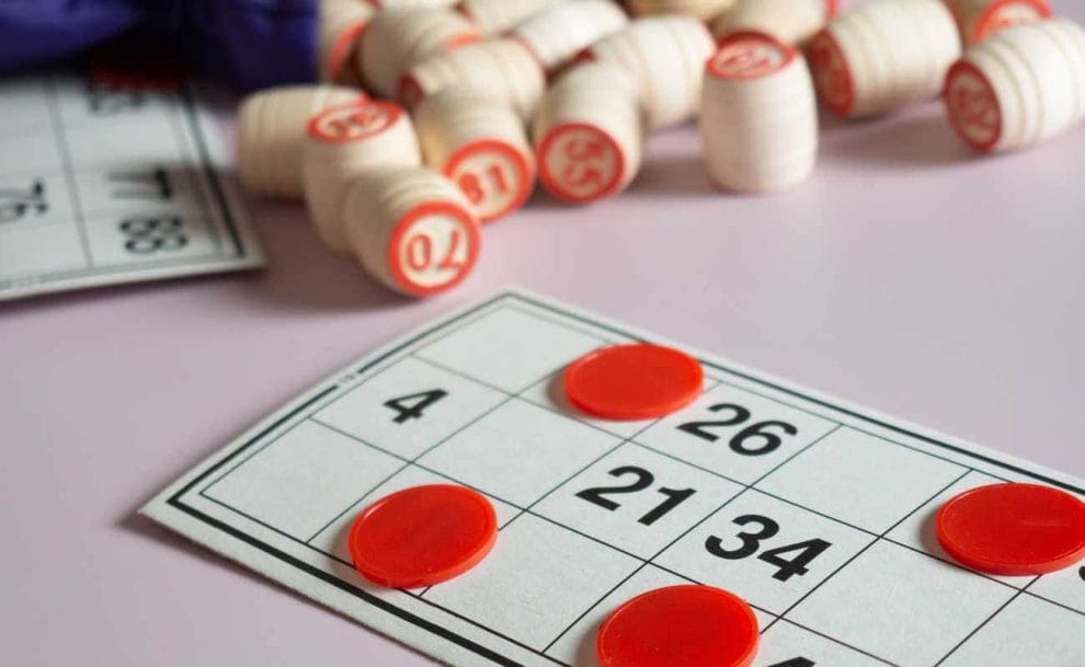 Bingo markers and bingo cards on a table.