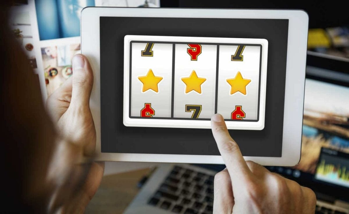 A person plays slots on a tablet