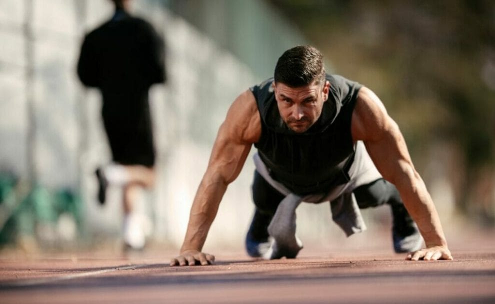 A man straining while doing a pushup.