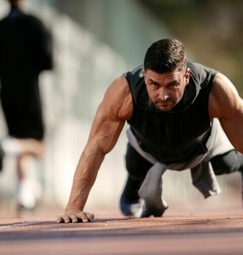 A man straining while doing a pushup.