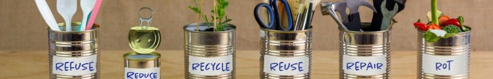 Tin cans with zero waste management messages written on each one.