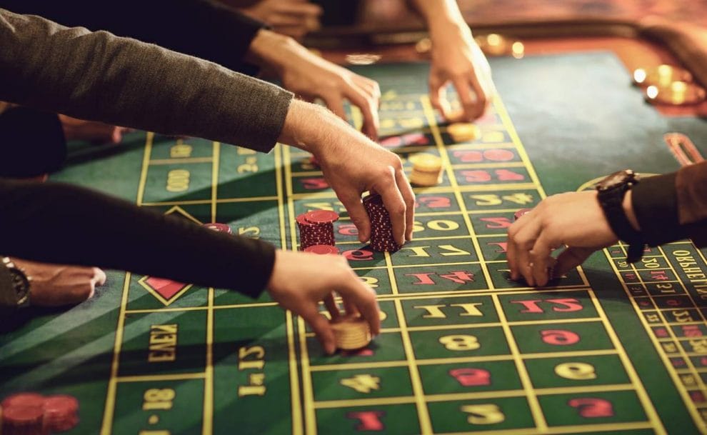 Roulette players placing their bets on a roulette table.