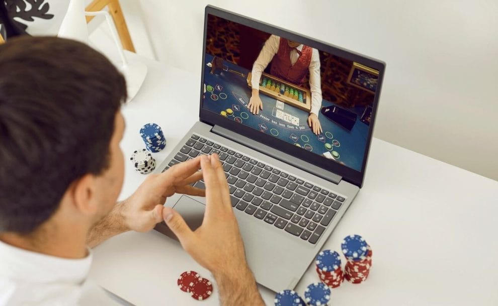 A person playing an online casino game on their laptop.