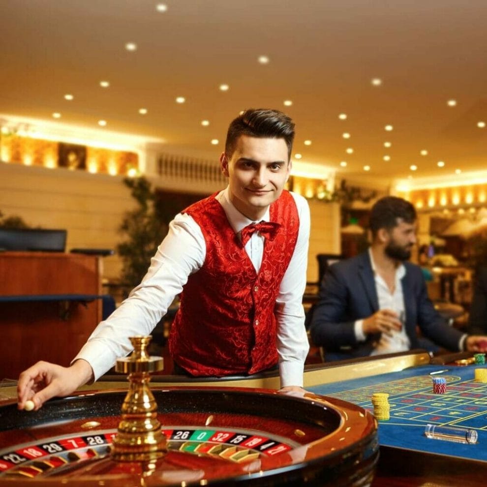 A roulette dealer about to start a game of roulette.