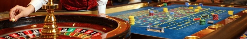 A roulette dealer about to start a game of roulette.