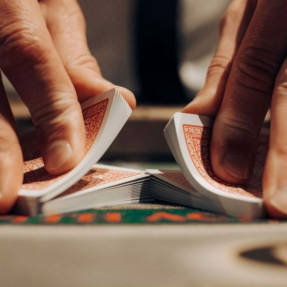 A man’s hands shuffling playing cards