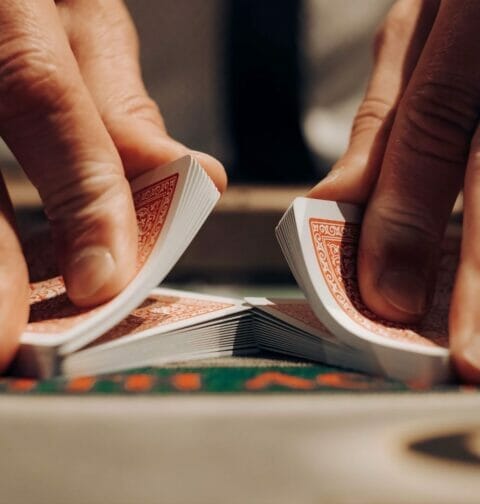 A man’s hands shuffling playing cards