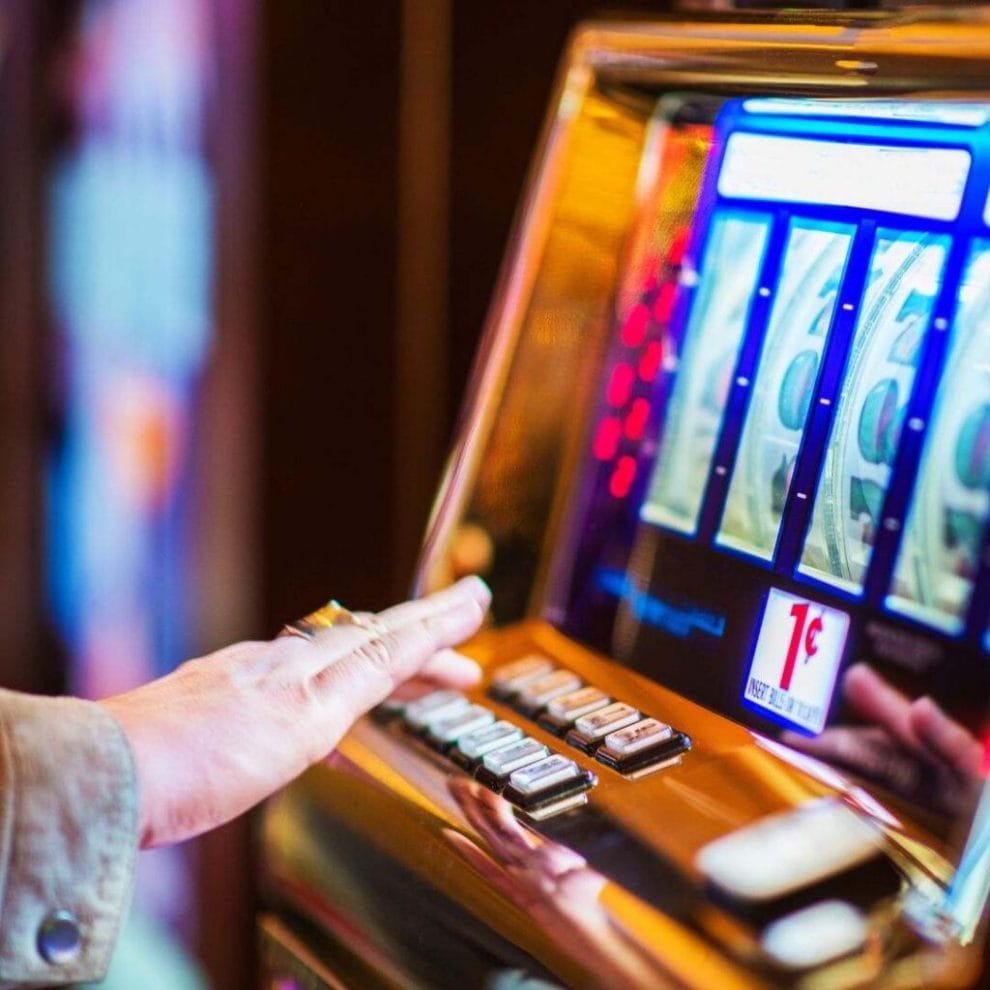 close up of someone playing a casino slot machine