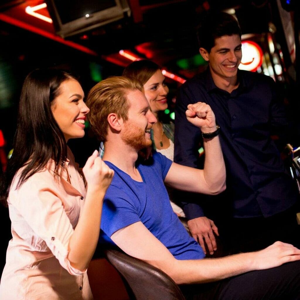 Header image - friends celebrating a win playing casino games in a casino