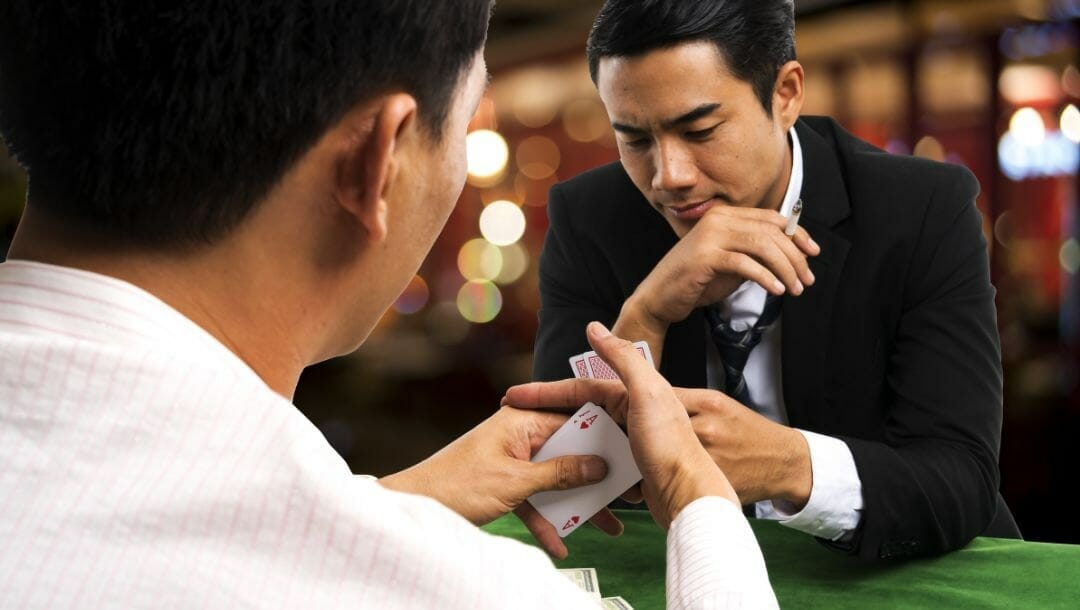 Body image, two men playing poker against each other, sitting opposite to each other