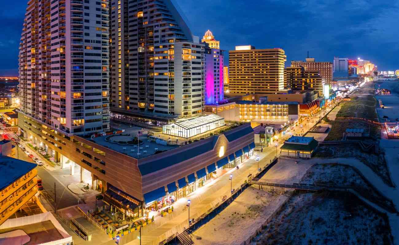 an aerial panoramic view of Atlantic city along the boardwalk at dusk