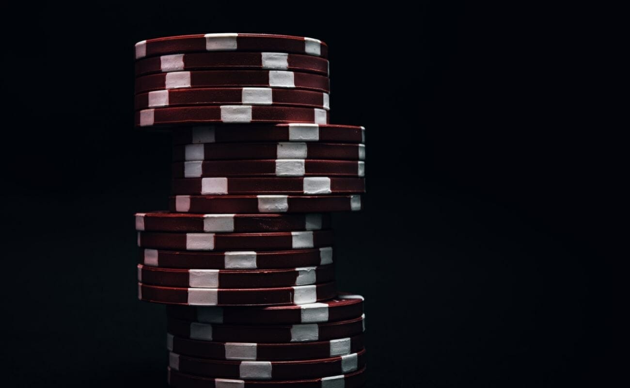 red poker chips stacked with a black background 