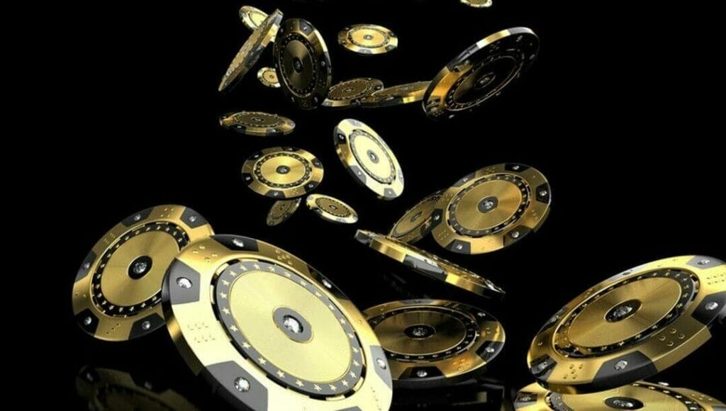 Luxury gold and black casino chips tumbling.