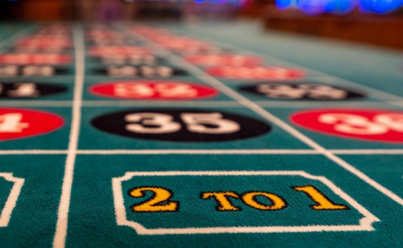 A close-up of bets on a roulette table.