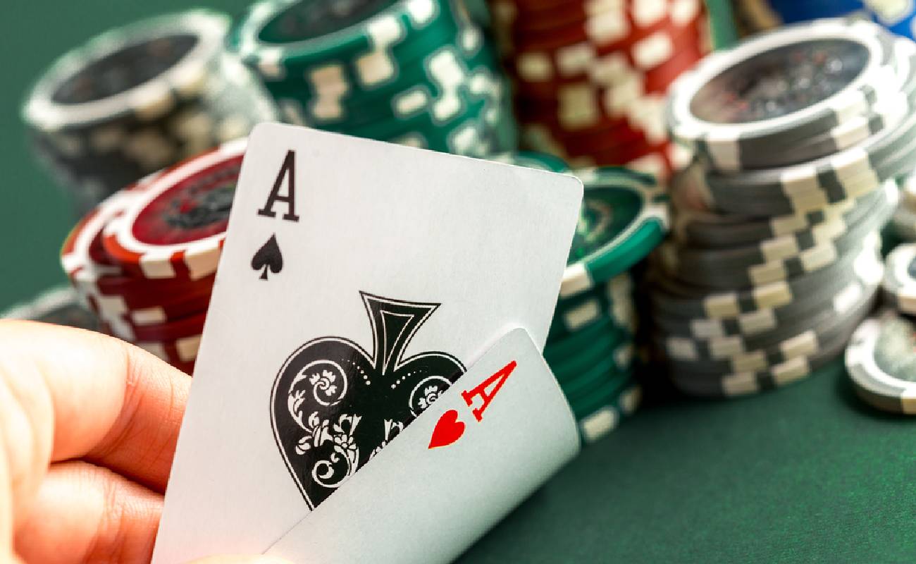 A poker player with an ace pair and chips in the background
