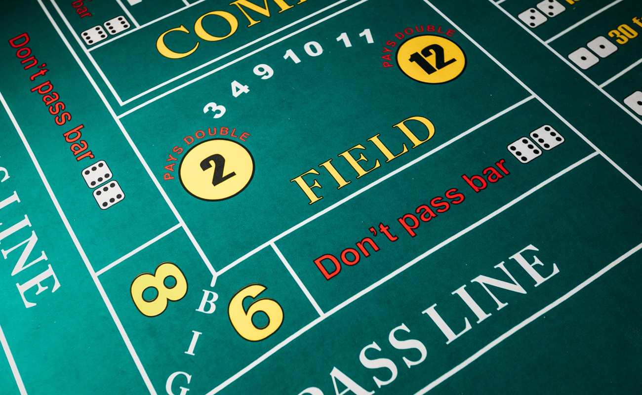 A close-up of a craps table. The field bets, don’t pass bar, pass line and other bets are visible.