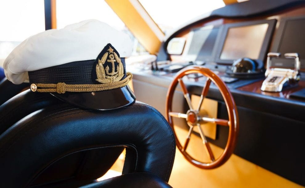 A captain’s hat on a leather seat on a cruise ship