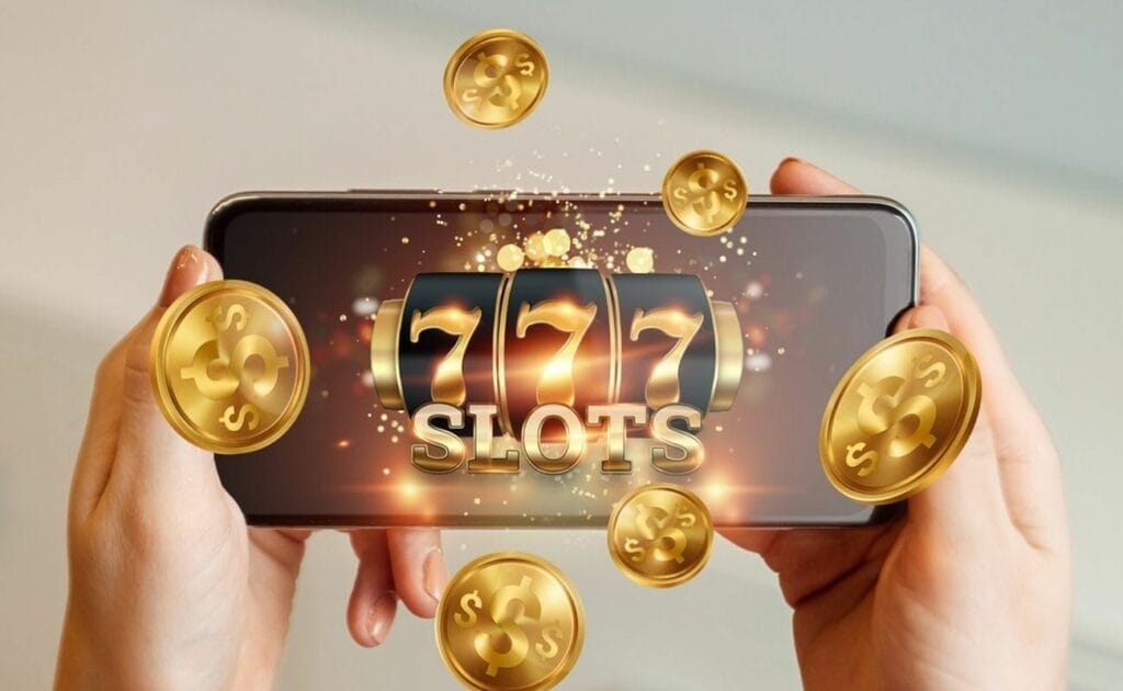 A smartphone featuring online slots with coins coming out the screen.