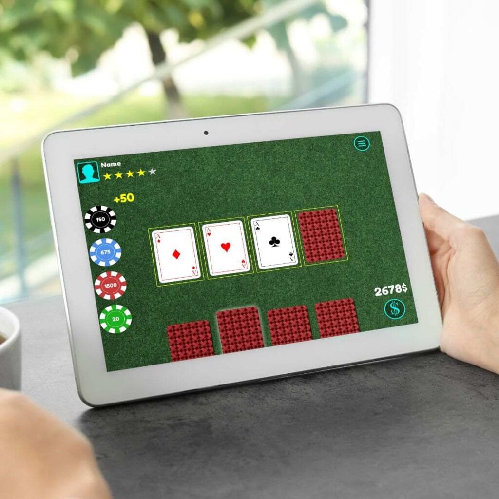 a person holding a digital tablet and playing online poker on it