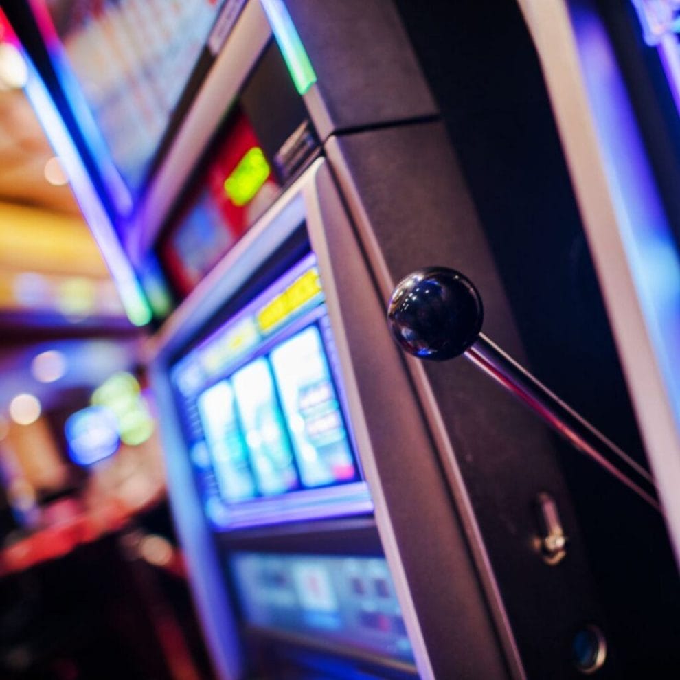 close up of a slot machine with a handle bar in a casino