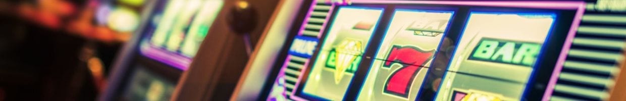 close up of a slot machine with a handle bar in a casino