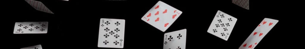 playing cards falling through the air with a black background 