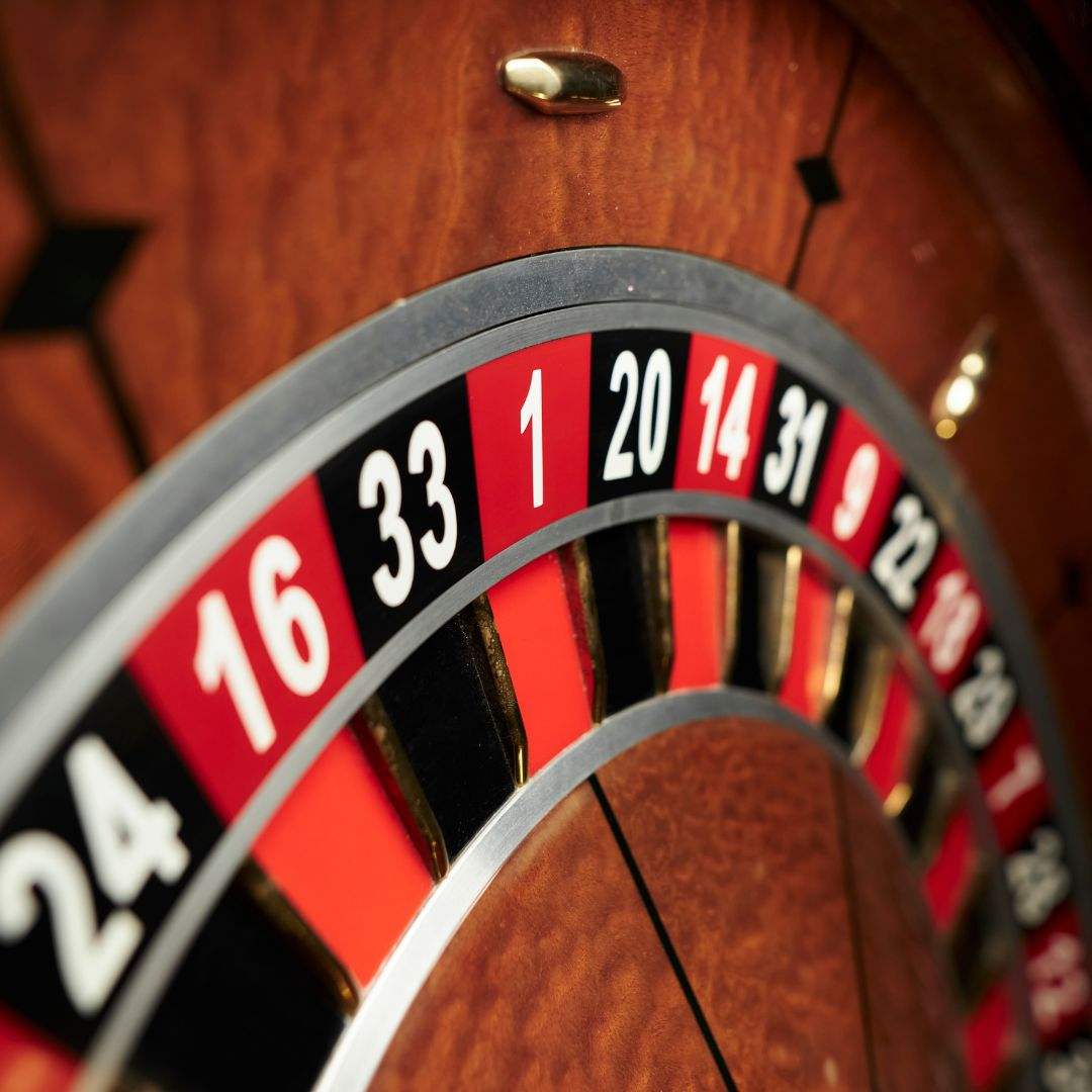 close up of a wooden roulette wheel in a casino