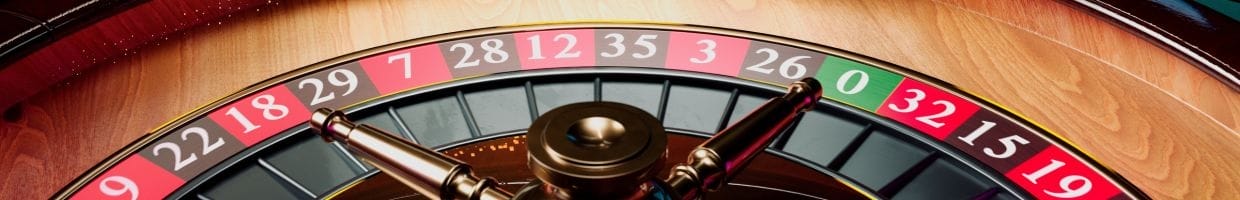 close up of a wooden roulette wheel in a casino
