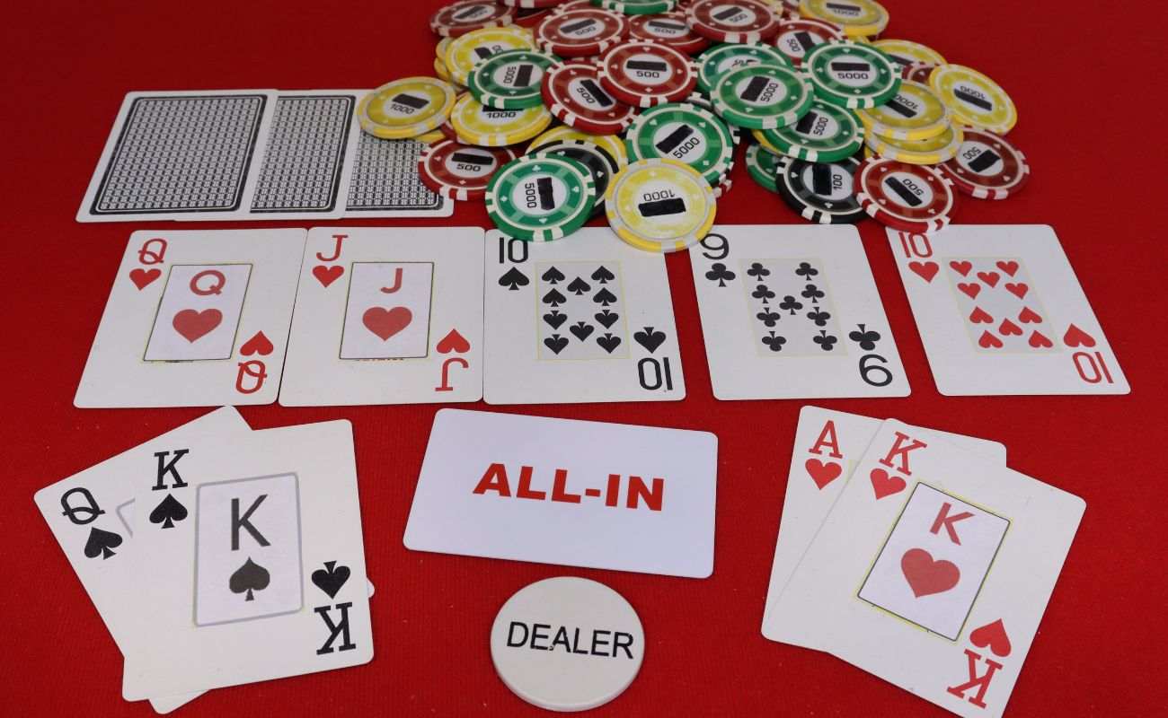 types of gunshot draws in a game of poker, playing cards and poker chips on a red poker table 