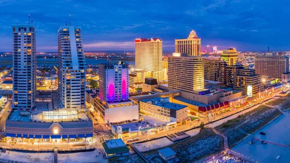 A panoramic image of Atlantic City, New Jersey along the boardwalk at dusk.