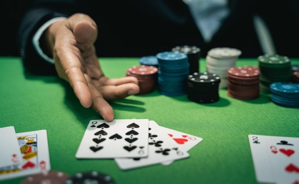 A player puts down cards on a poker table