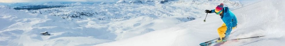  a person skiing down snowy mountains 