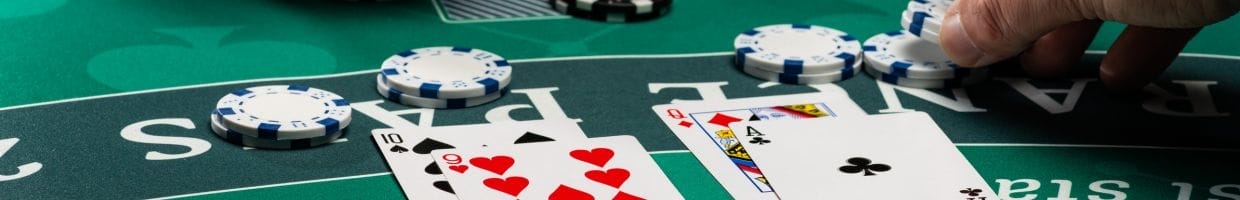 A person collecting casino chips during a game of blackjack