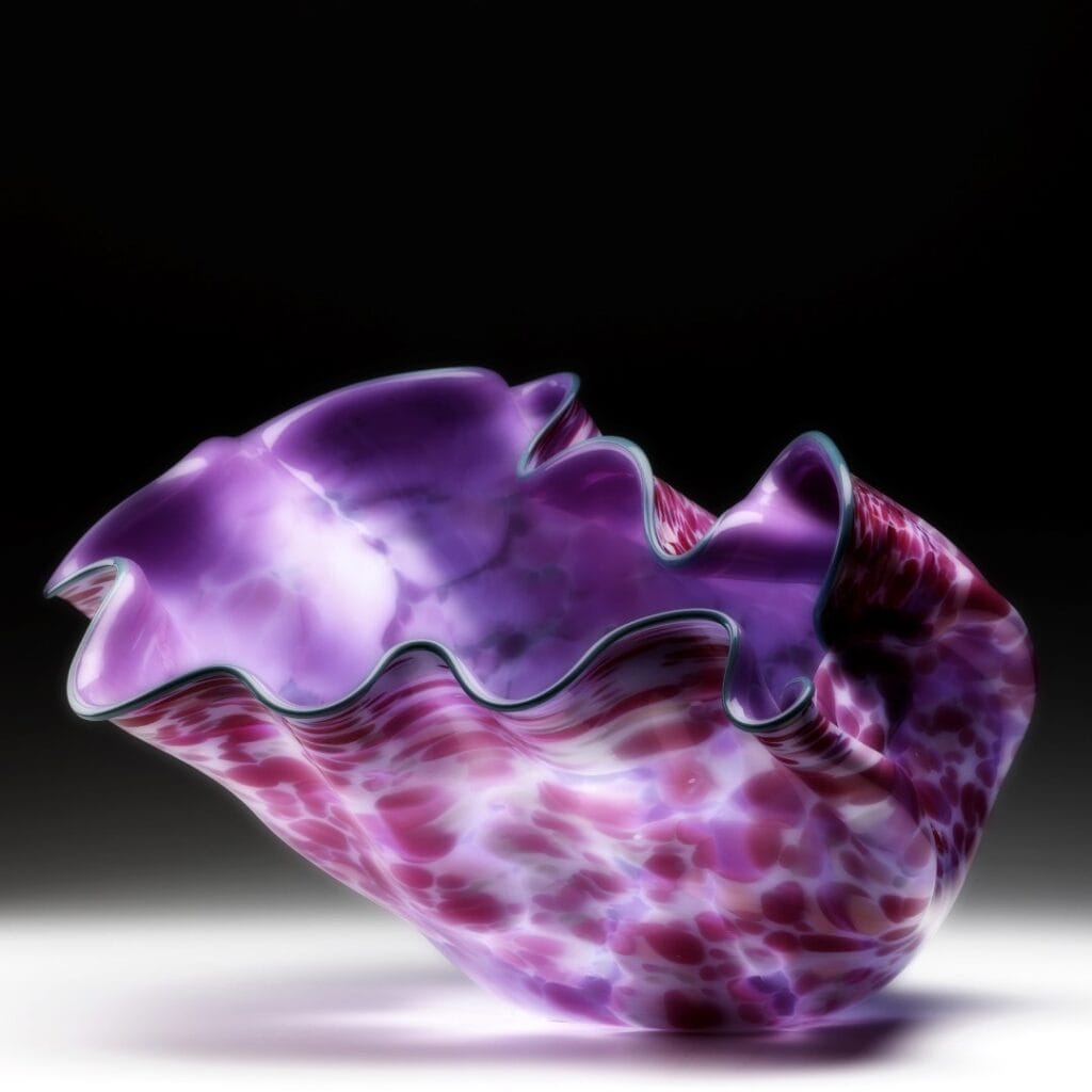 Free form glass vase with swirling color patterns