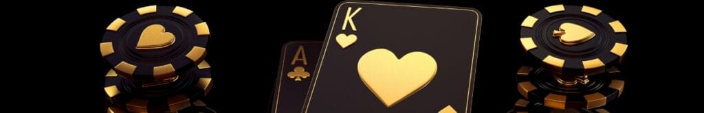 Ace and king gold and black playing cards with casino chips.