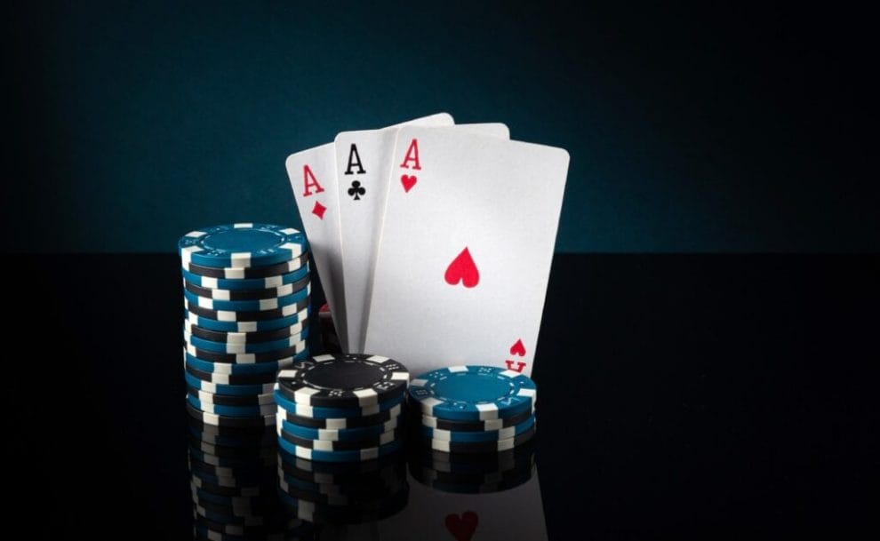 Poker cards with black and blue casino chips.