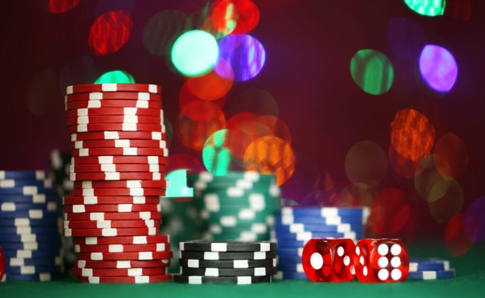 Colorful poker chips on a green felt table.