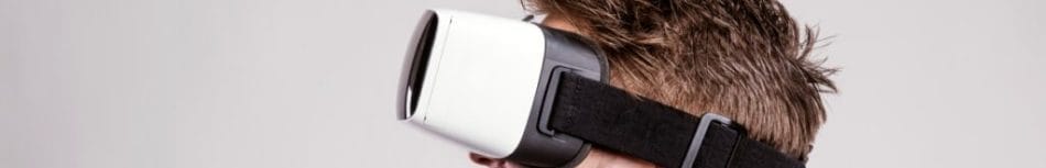 A person wearing a white and black VR headset.