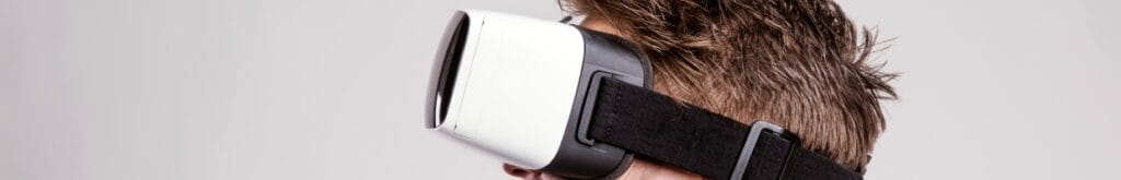 A person wearing a white and black VR headset.