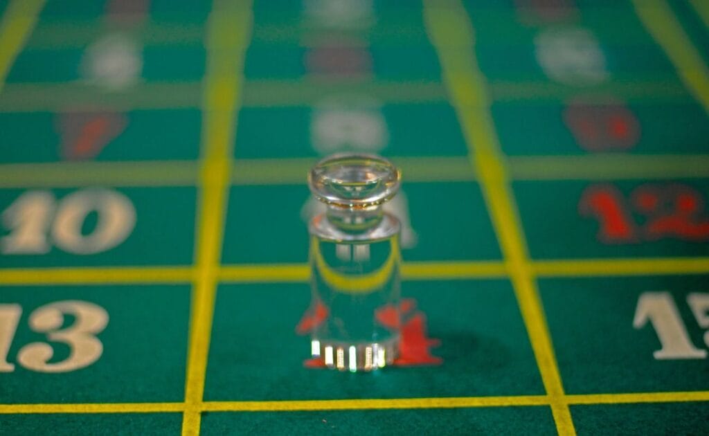 close up of a clear glass roulette marker on number 14 on a roulette table
