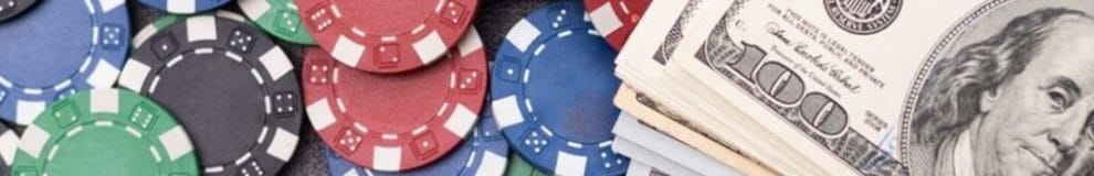 $100 bills stacked on top of colorful casino chips.