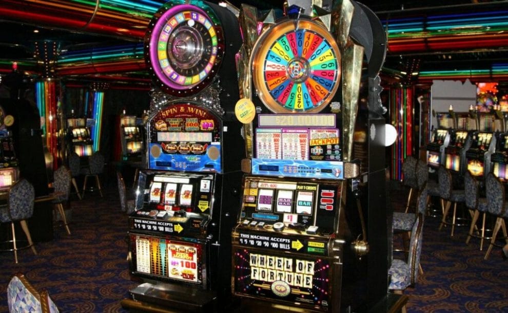Two old slot machines in a casino.