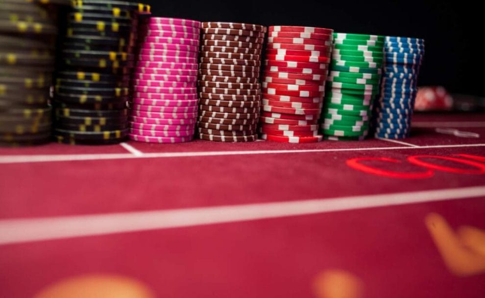 A line of colorful casino chips on a baccarat table 