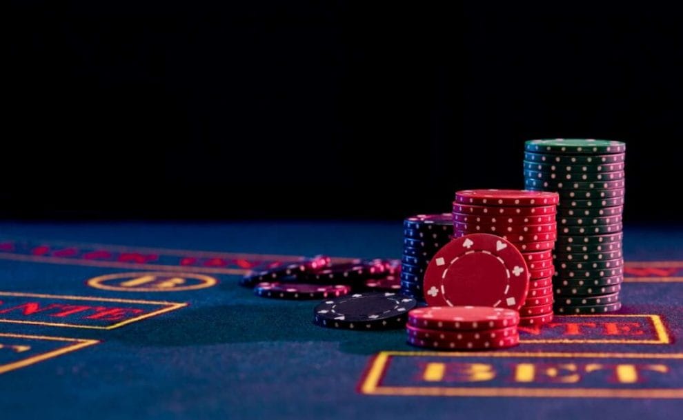A pile of casino chips on the ante bet section of a baccarat table