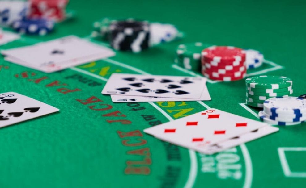 Piles of cards and chips on a blackjack table.