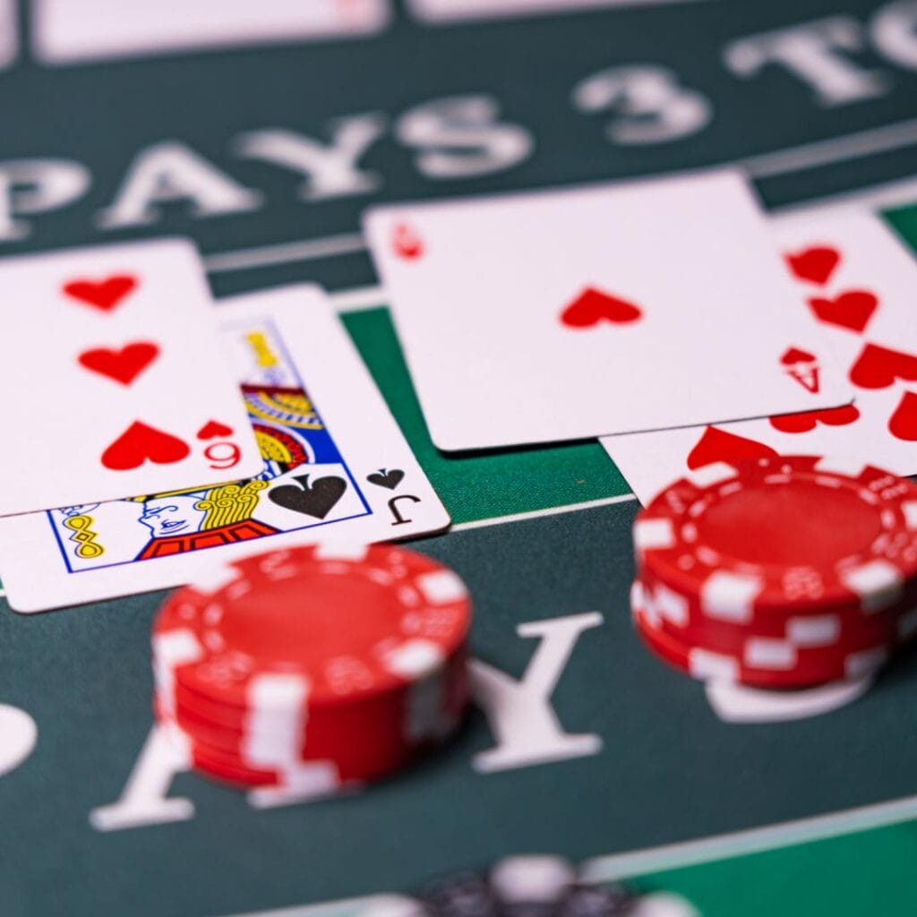 Close-up view of cards and chips on a blackjack table.
